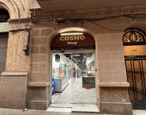 Cosmo Shop entrance at Joaquín Costa 66, with its arched sign and the number 66 beside the door
